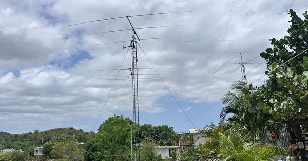 KP4AA contest station antenna farm against the Puerto Rico sky - stacked yagi towers seen from the pool during the IARU HF Championship 2026