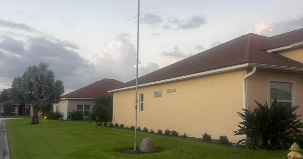 KA8JIL's Greyline DX Flagpole HF antenna flying the American flag in a Lake Wales, Florida HOA after new insulators, standing perfectly vertical