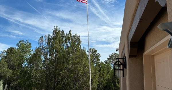 W7MNE's Skyline 33 fully dressed: 24 ft Greyline flagpole antenna flying the American flag with the 9 ft DX Whip mounted above a working flag light