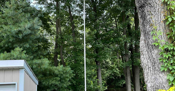 A 28-foot Greyline DX Flagpole antenna installed at an Ohio home station -- the antenna every grounding and bonding plan protects