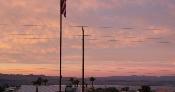 Greyline DX Flagpole antenna at sunrise - an HOA-compliant HF vertical dipole with both halves of the antenna in the air and no radials in the yard