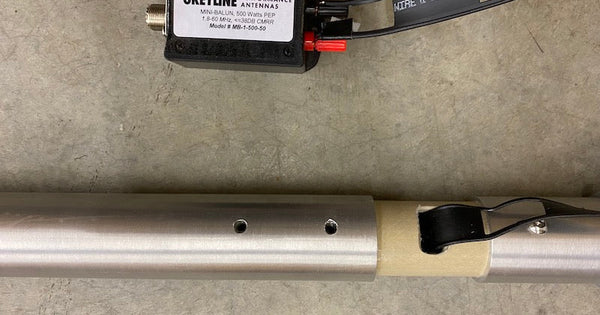 Greyline RF current choke installed in the feed system of an HF vertical flagpole antenna with ladder line and coax