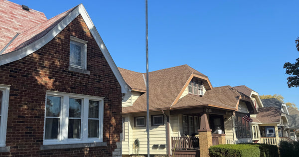 N9VJY's 20-foot Greyline DX Flagpole in West Allis, Wisconsin, flag lowered, a clean ground-mounted HF vertical dipole install