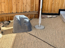 Load image into Gallery viewer, Greyline Tilt-Up Base installed at ground level under a 24-foot DX Flagpole, with a faux landscape rock covering the remote antenna tuner. Owner install, Spanish Springs, Nevada.
