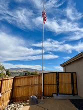Load image into Gallery viewer, 24-foot Greyline DX Flagpole antenna installed in a Spanish Springs, Nevada front yard, American flag flying, clear blue sky. Owner KB6FRD worked Hawaii on 17 meters with 100 watts.